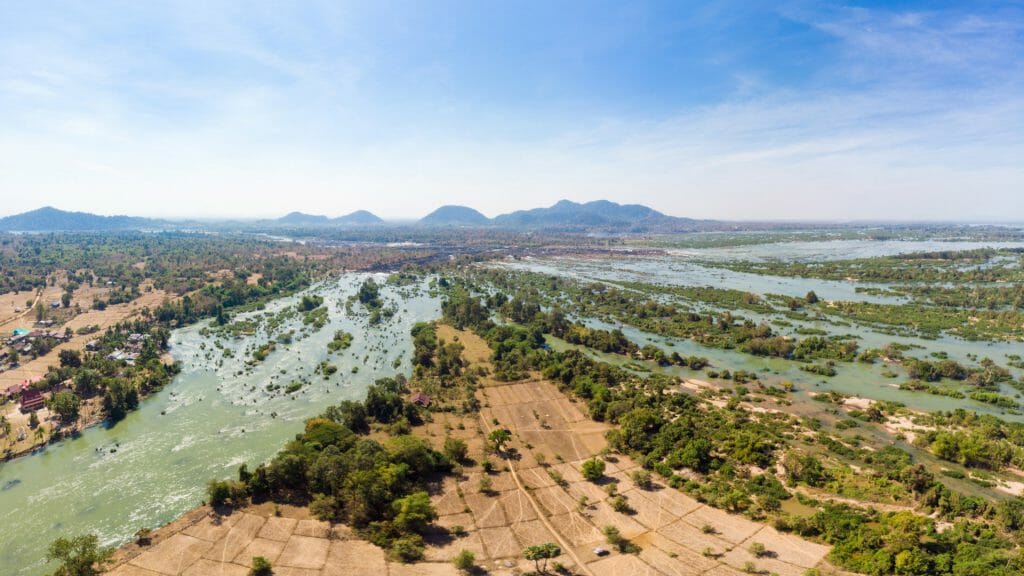 Aerial view of a river delta with many tributaries and jungle covered islets.