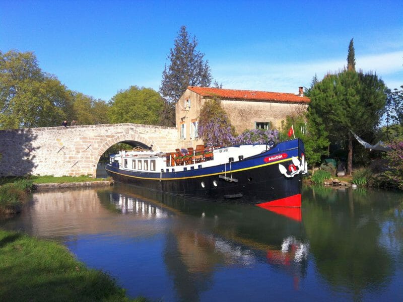Barge sailing through bridge, French Canal Holiday, France