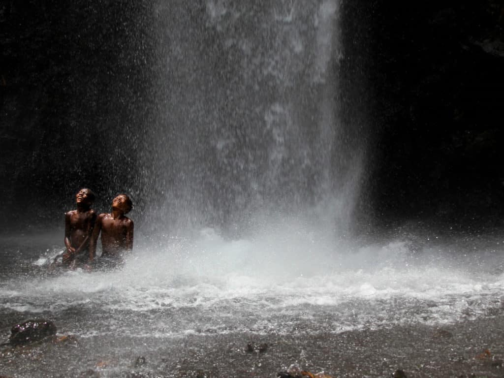 Children at waterefall Long Island, Papua New Guinea