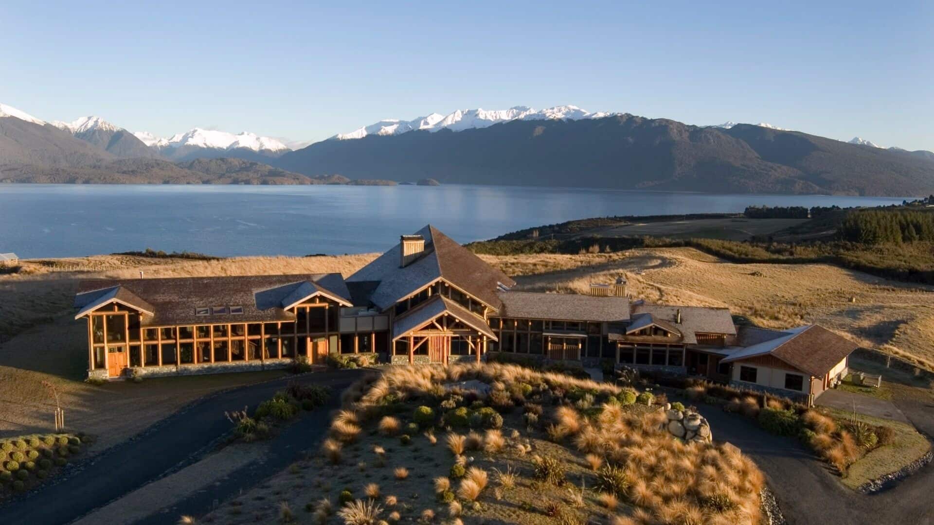 Aerial view of Fiordland Lodge situated on the pristine, dramatic shores of Lake Te Anau in New Zealand.