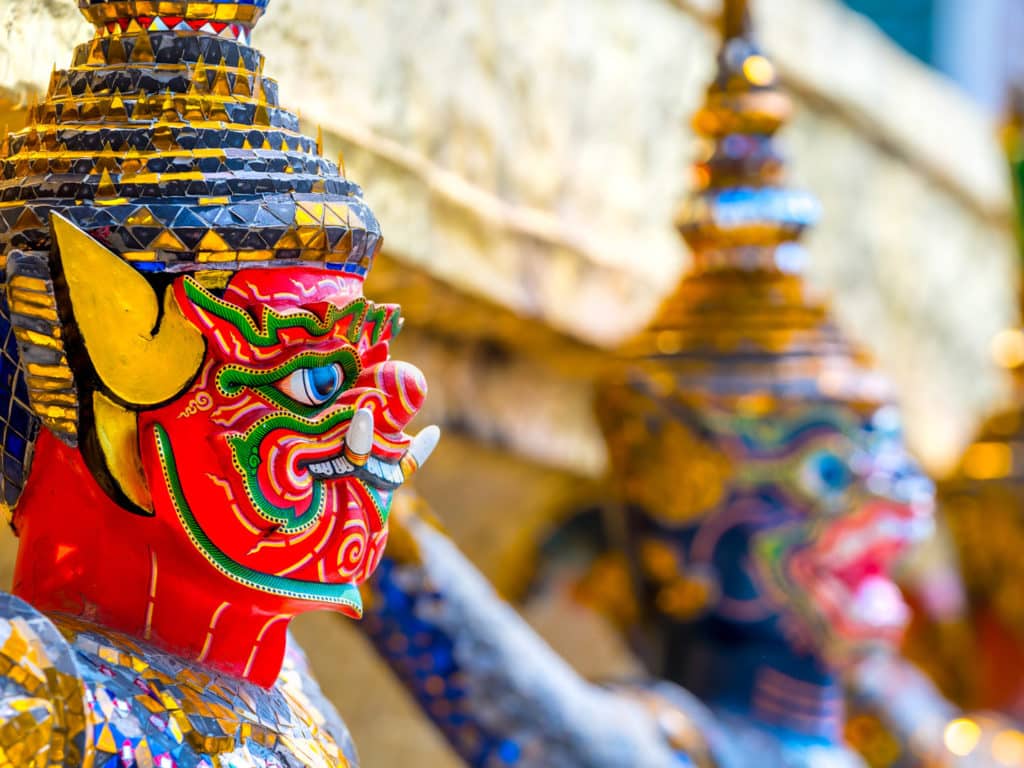 Close up of colourful decorative faces adorning the grand palace.