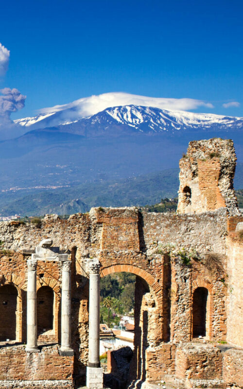 Greek Roman Theater with Etna erupting, Taormina, Sicily, Italy