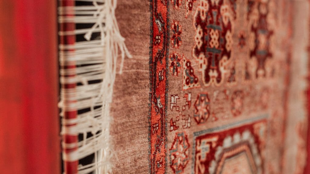 Full frame close up of patterned red carpet.