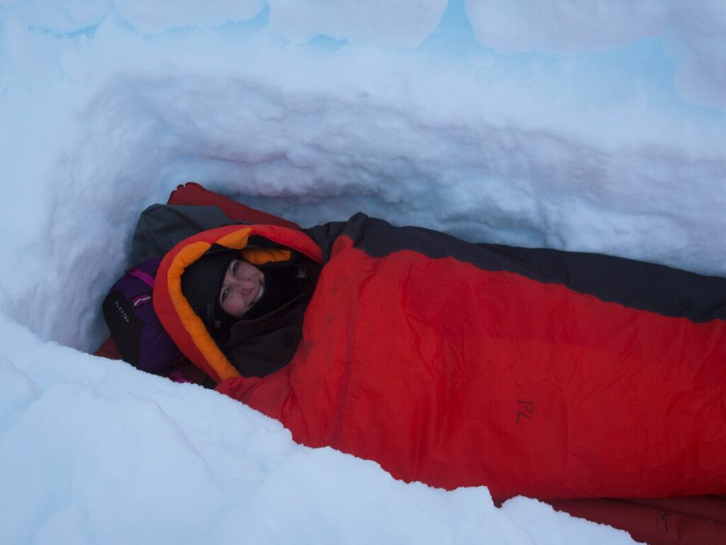 Single person in red bivy sack in ice, Antarctica