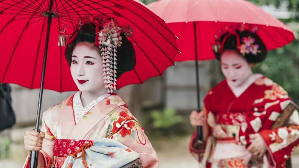 Maiko geisha walking on a street of Gion in Kyoto Japan