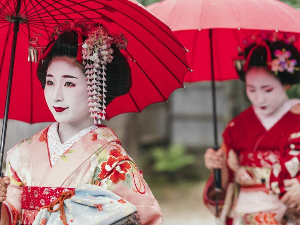 Maiko geisha walking on a street of Gion in Kyoto Japan