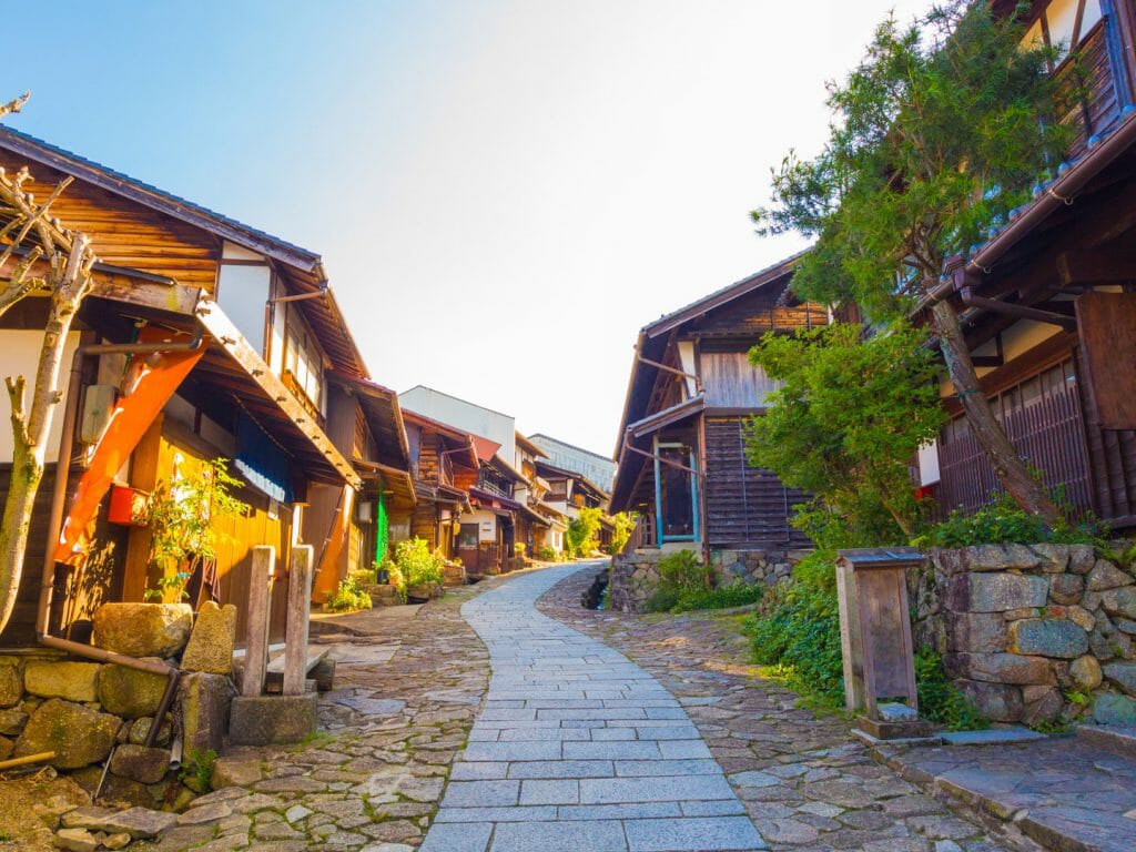Narrow paved path leading up between Japanese Houses.