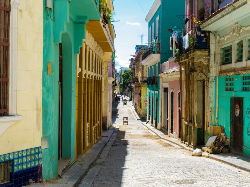 street sidelined by colorful old buildings in Havana, Cuba