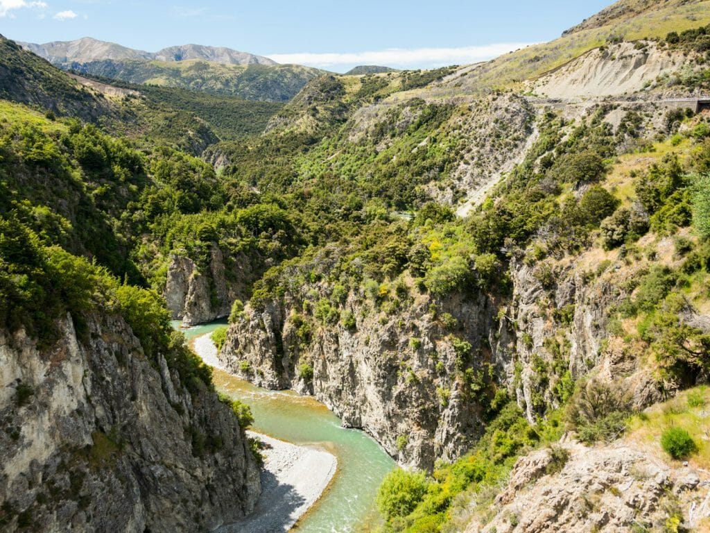 View from the train windows of TranzAlpine railway over Waimakariri river gorge on journey to Arthurs Pass