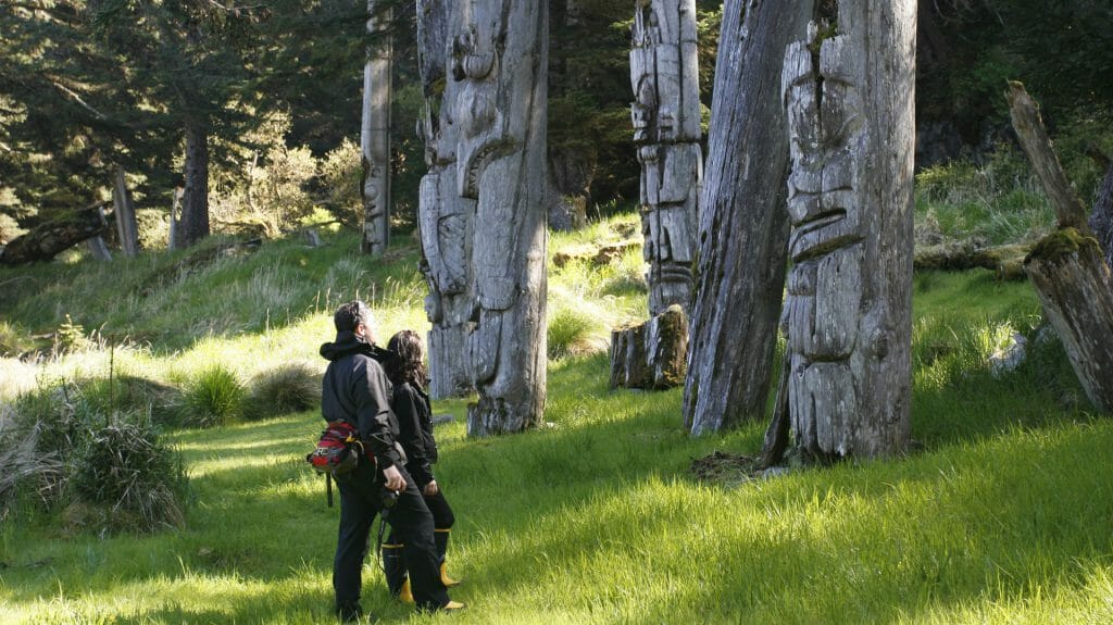 Viewing totems, SGangGwaay, by Kevin J Smith, Haida Gwaii, Canada