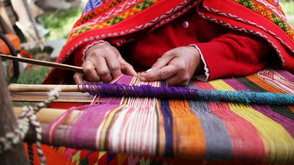 Local woman weaving textiles, Peru