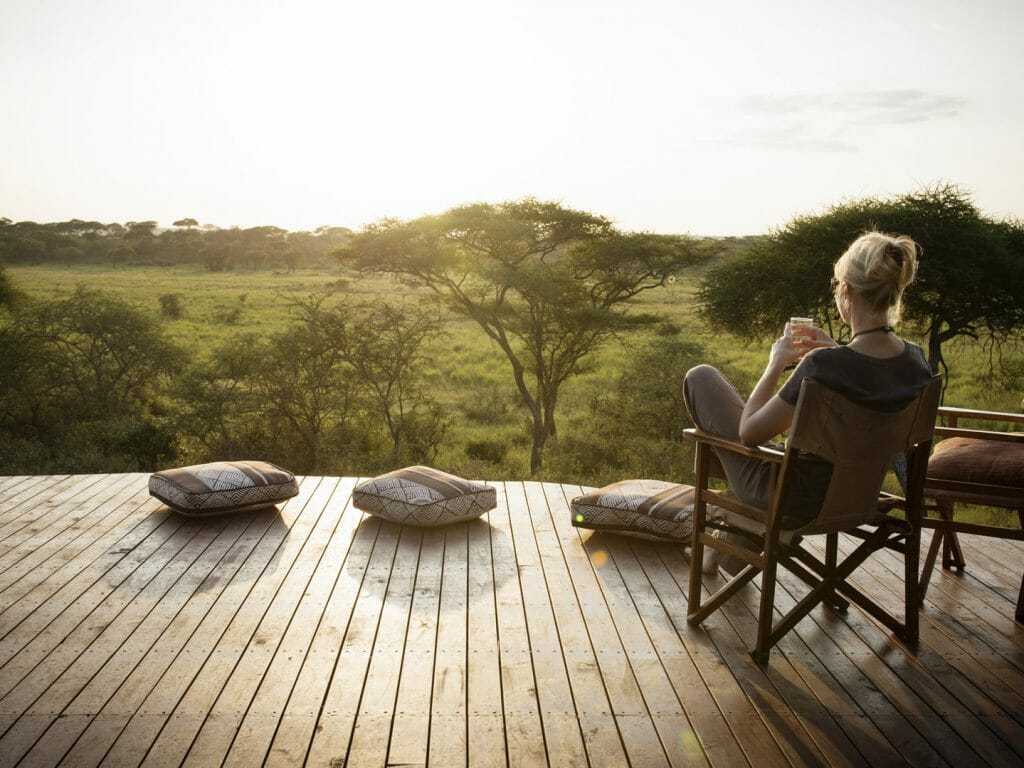 Relaxing on the verandah overlooking the floodplains, Oliver’s Camp, Tarangire, Tanzania