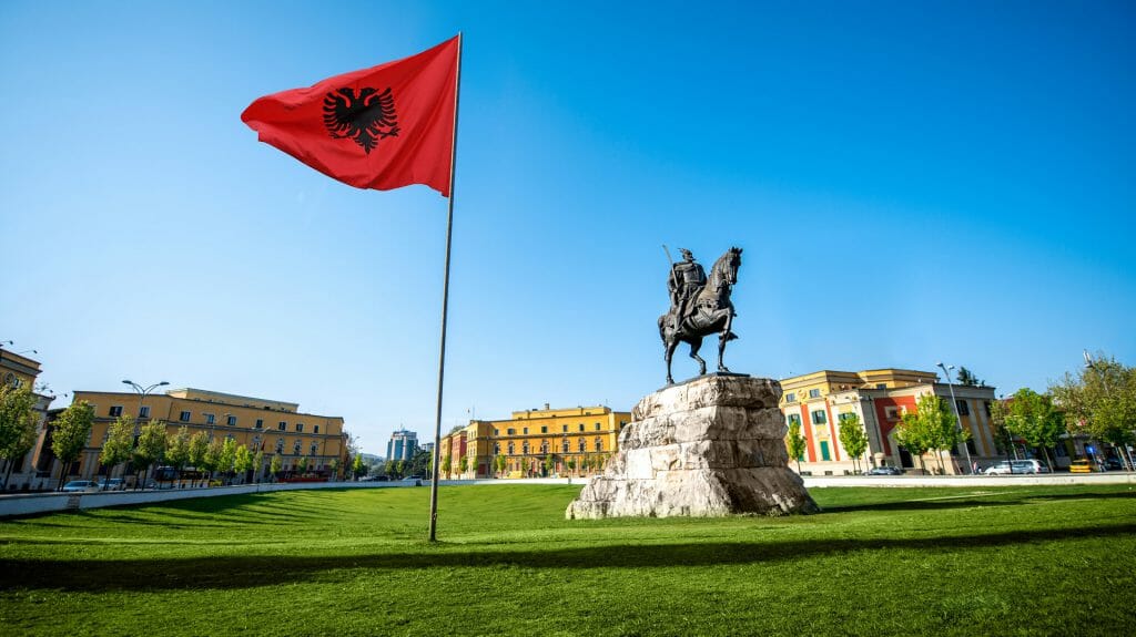 Skanderbeg square with flag and monument in the center of Tirana city in Albania