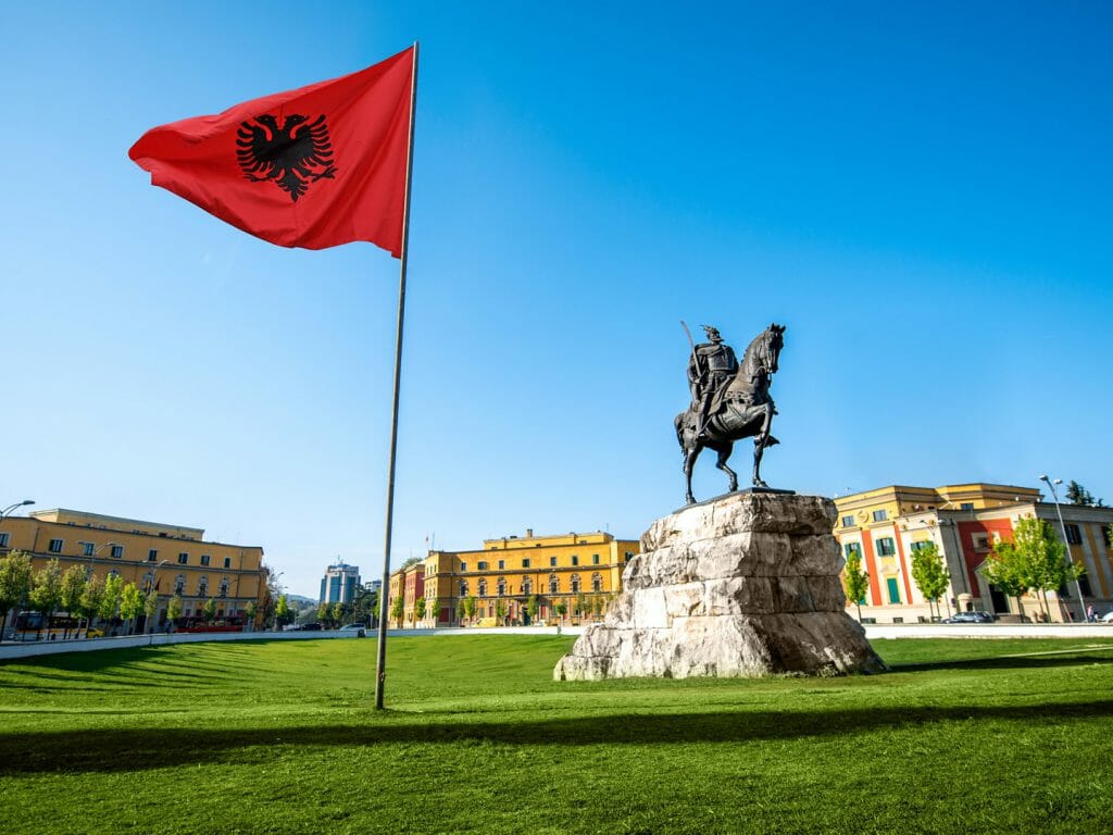 Skanderbeg square with flag and monument in the center of Tirana city in Albania