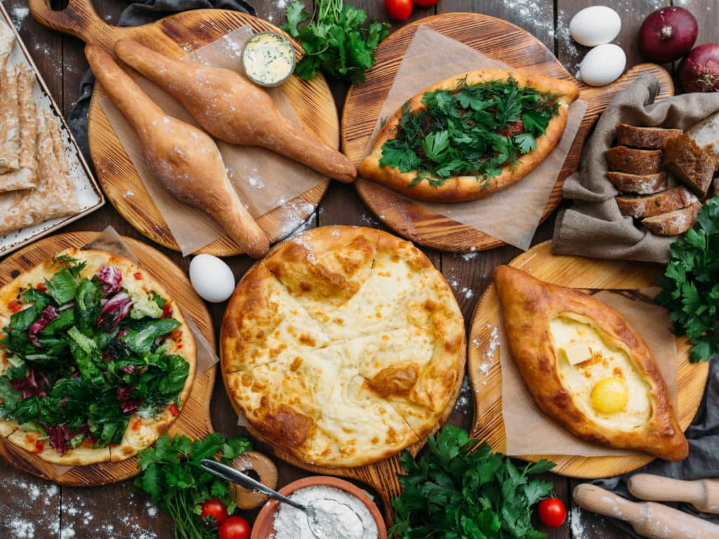 Traditional Georgian adjara khachapuri and Kolkh khachapuri on the table, Georgia