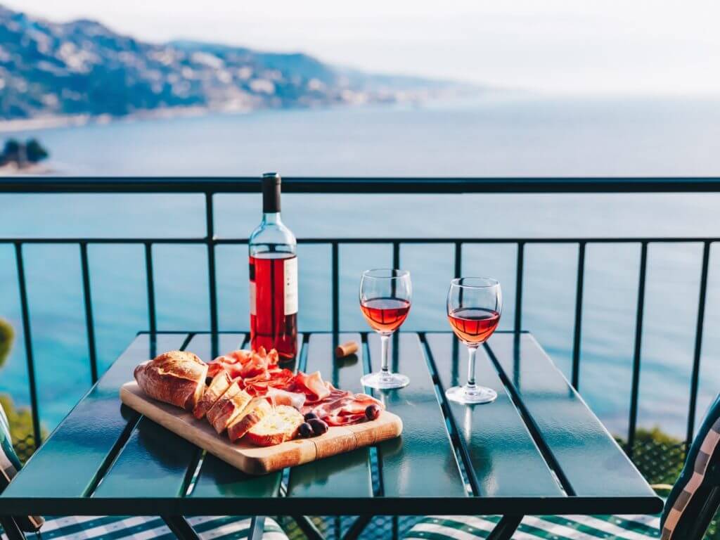 Romantic charcuterie dinner on a panoramic terrace overlooking the ocean in Italy