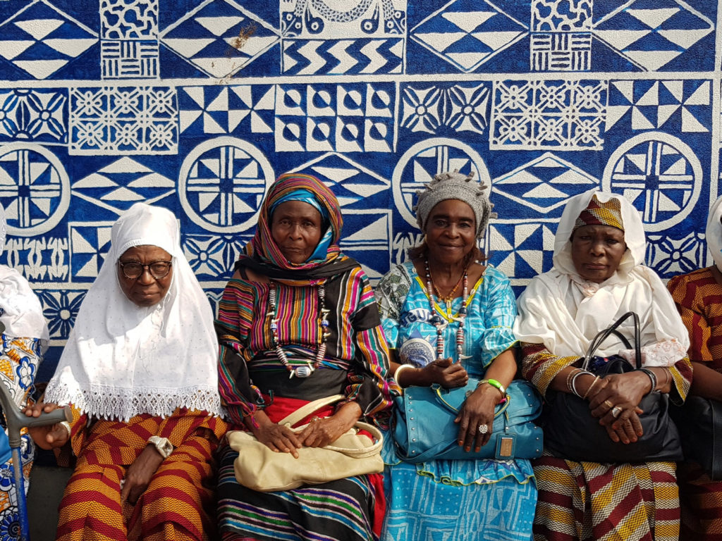 Women in front of wall, Foumban, Cameroon