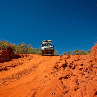 Western Australia – Outback track with 4WD car downhill to the ocean at Dampier Peninsula