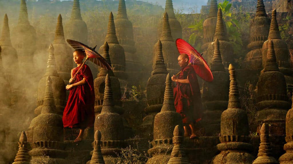 Buddhist monks walking with parasols, Pagoda, Myanmar