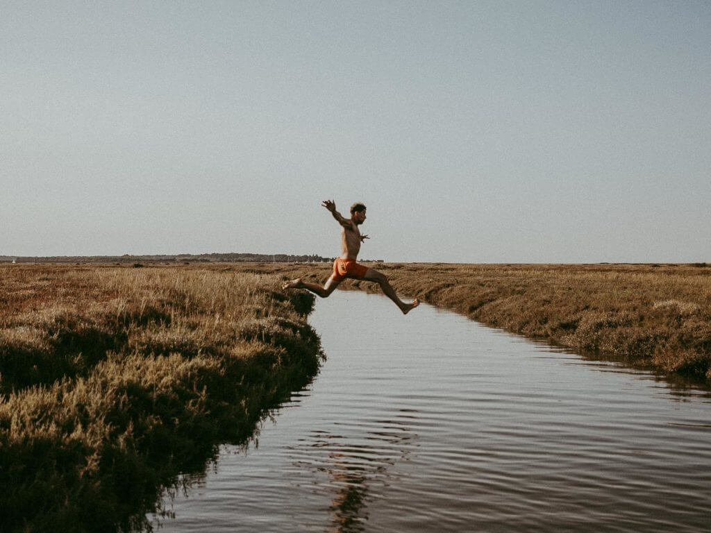 Man jumping into swim, Norfolk, England
