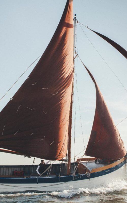 Whelk boat sailiing at sea, Norfolk, England
