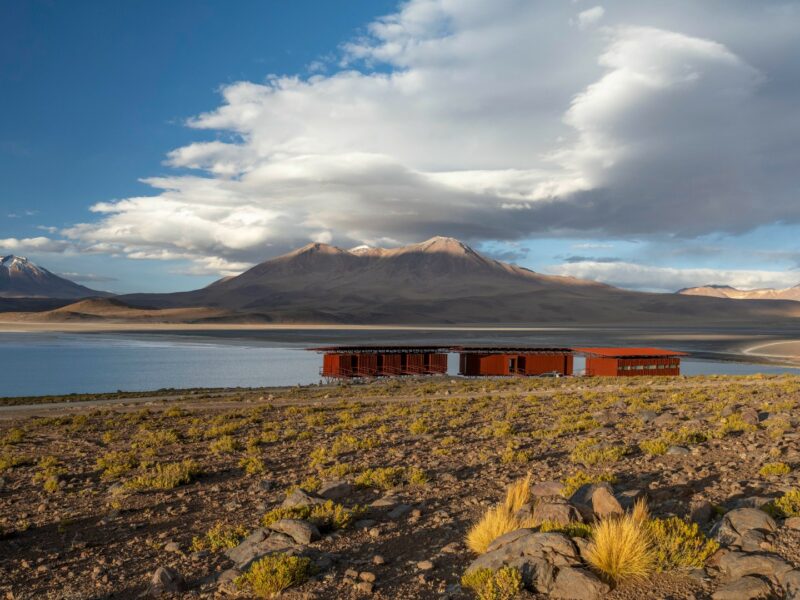 View of Explora Mountain Lodge in Ramaditas with lake and mountains beyond, Bolivia