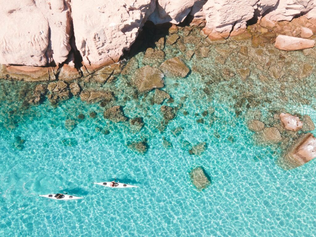 Aerial short of two kayakers just off coast, Baja California, Mexico