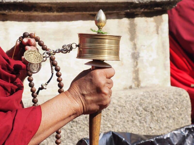 Monk with prayer wheel, Bhutan