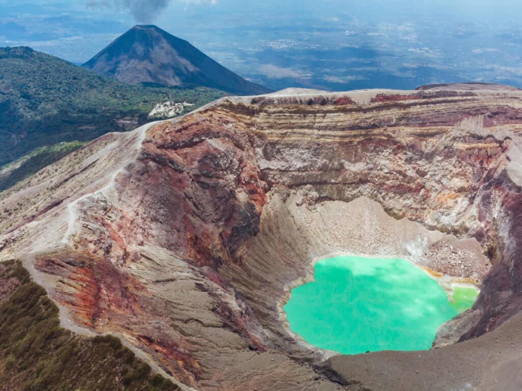 A bright turquoise, sulphuric crater lake at the summit of Santa Ana Volcano