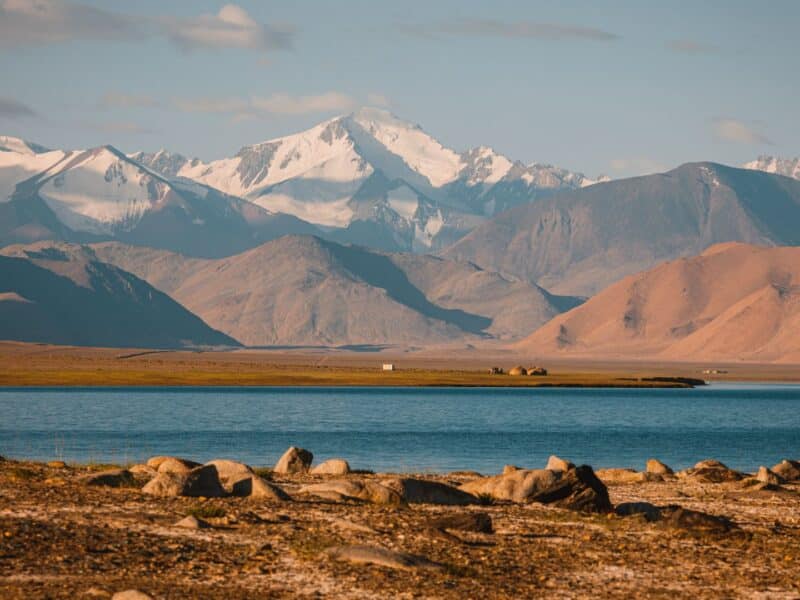 View across Lake Karakol to snow capped mountains, Tajikistan