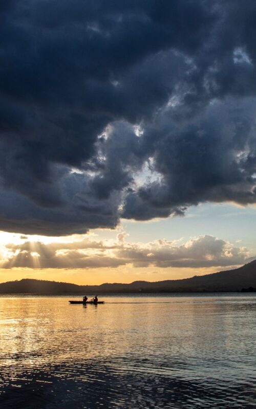 Kayakers at sunset, Lake Nicaragua and concepcion volcano, Nicaragua