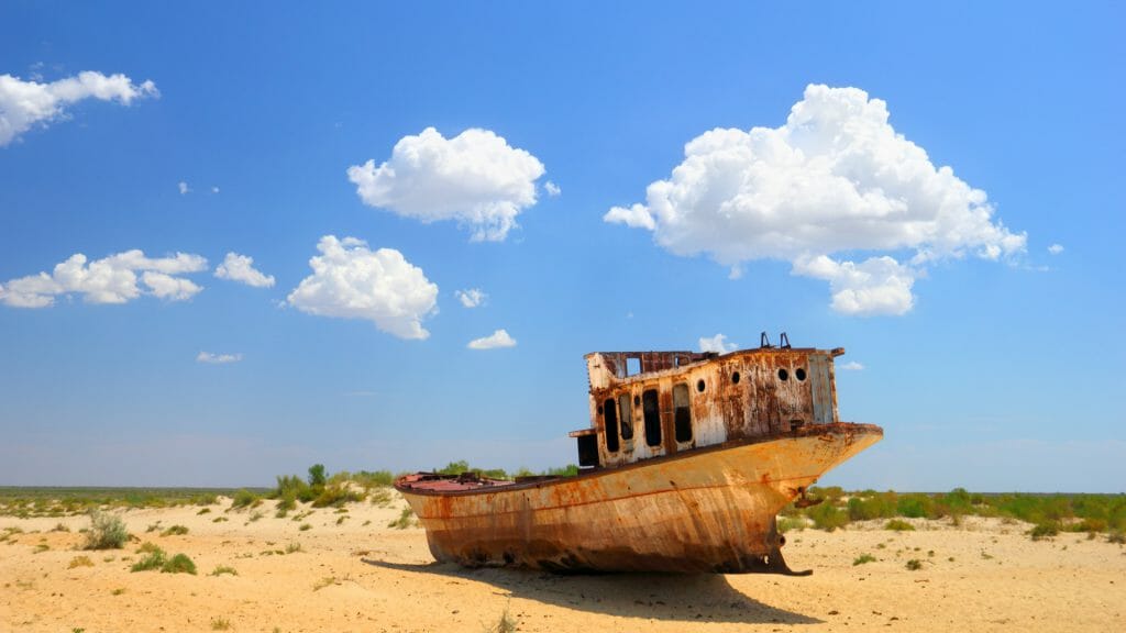 Rusting stranded ship in a desert landscape where the aral sea once was