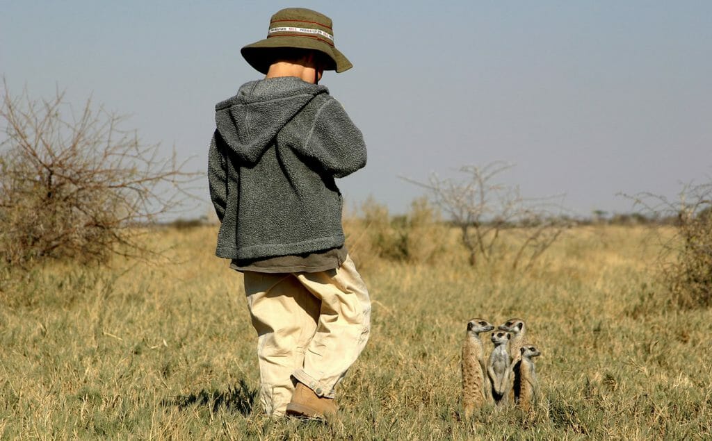 boy with meerkats, Makgadikgadi Pans, Botswana