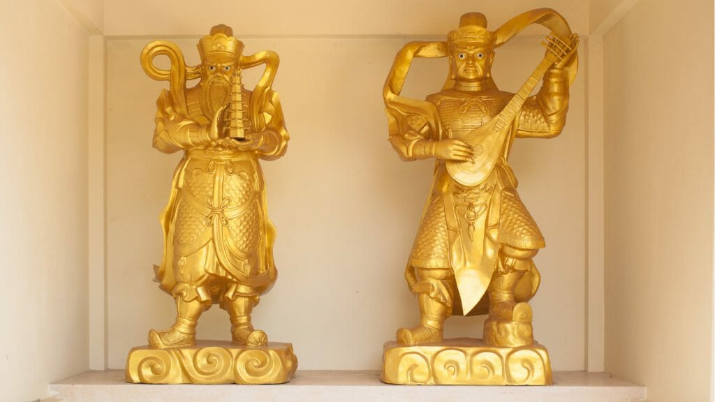 Two golden Buddhist statues on display
