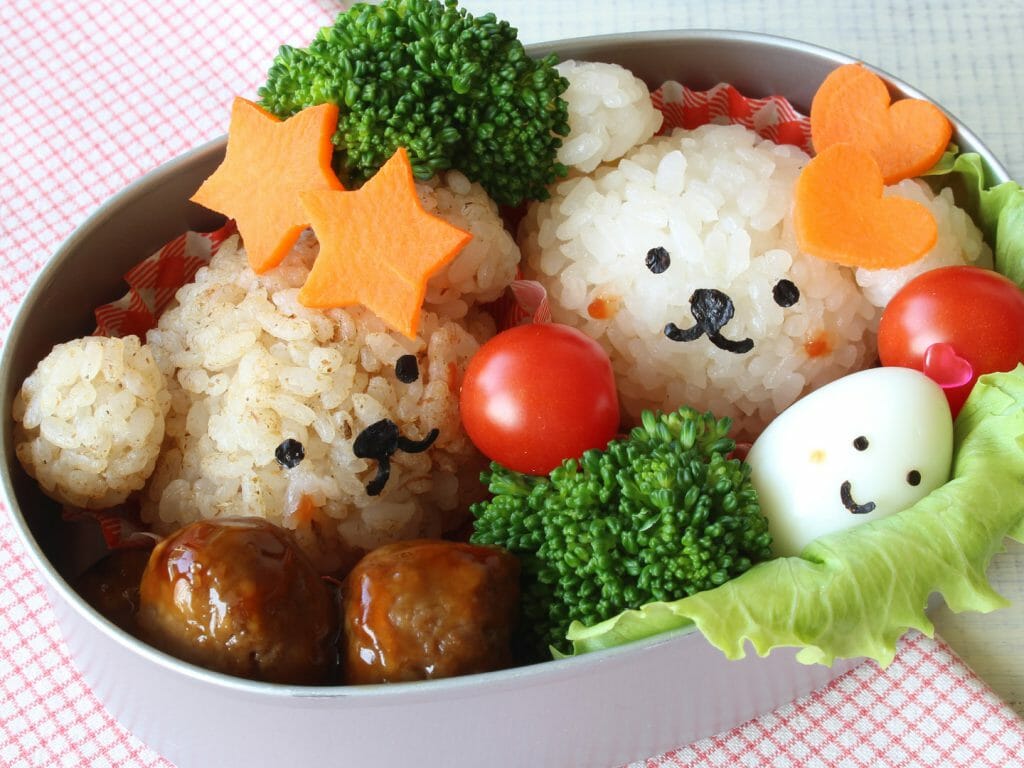 Close up of bento box with rice shaped like bears.