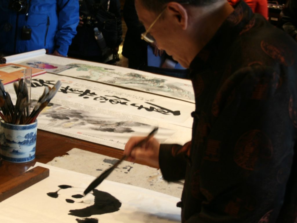 Chinese man painting a panda.