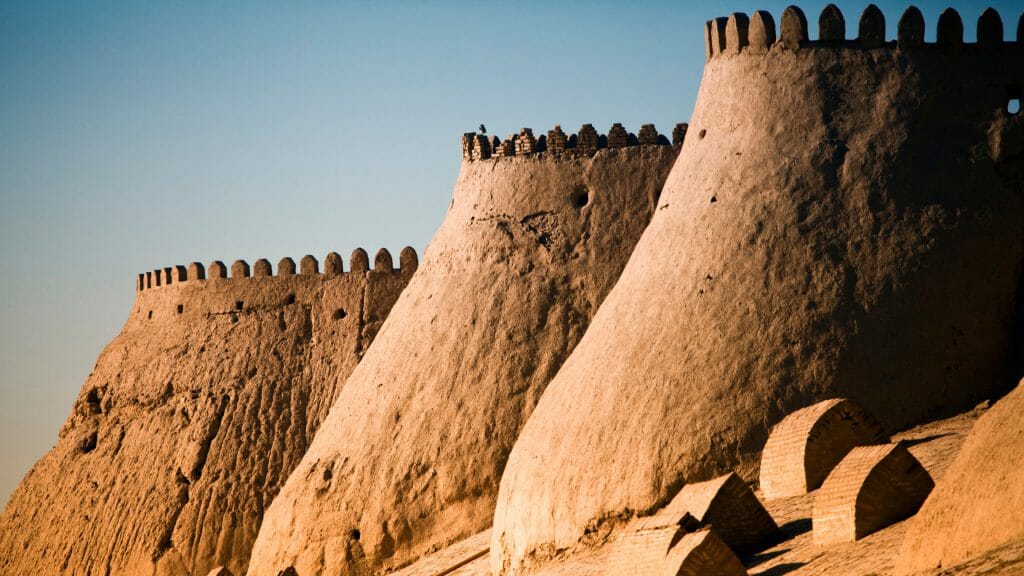 Curved mud brick walls and ramparts of  Khiva ancient city walls.