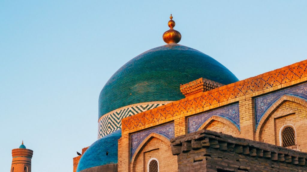 View of mosque dome against blue sky.