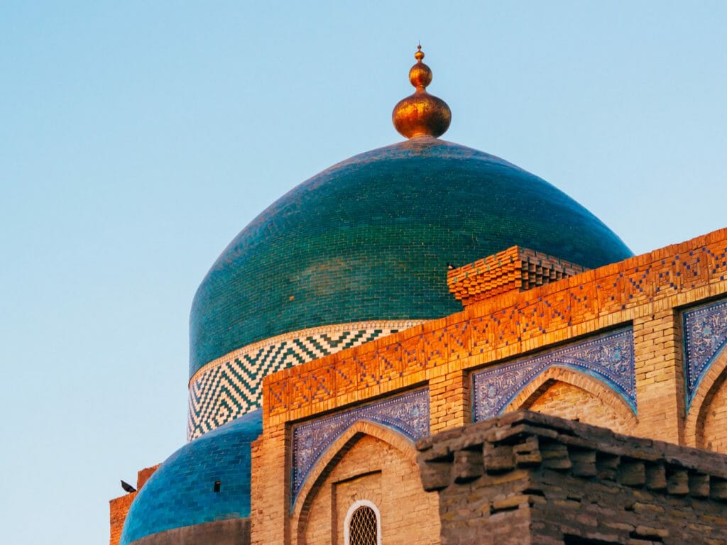 View of mosque dome against blue sky.