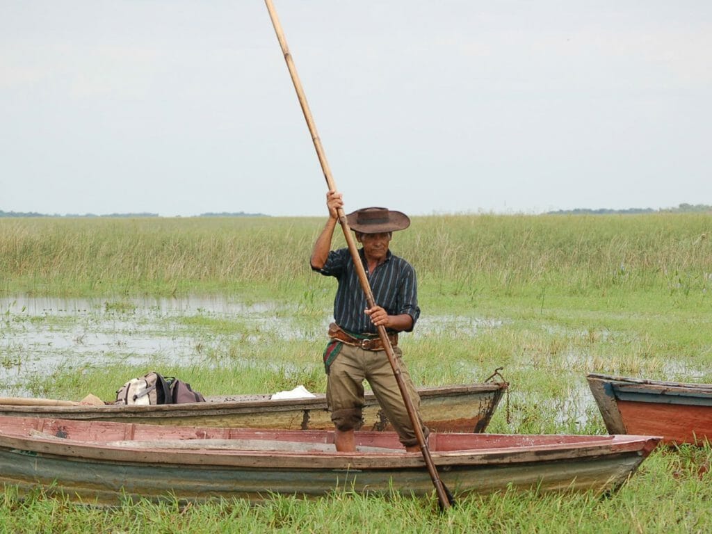 Local and his boats in swamp, Ibera Marshlands, Carlos Pellegrini, Argentina