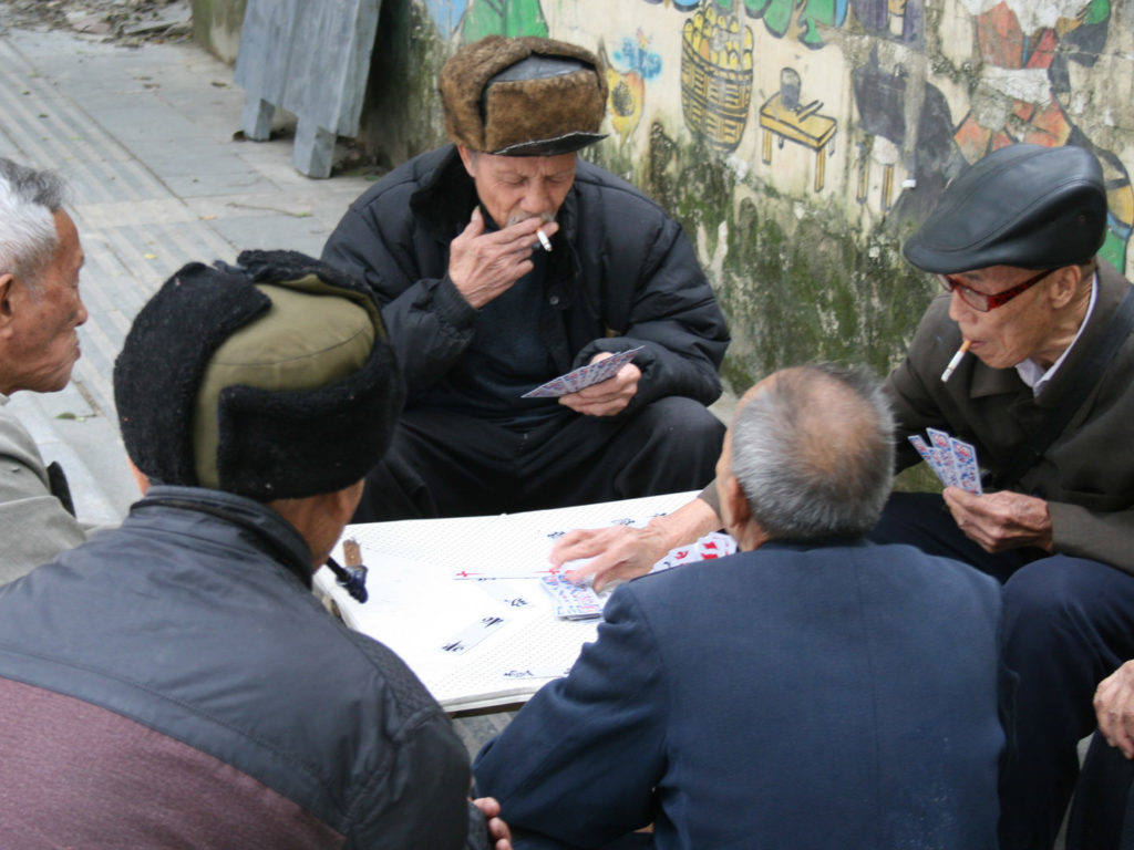 Local men playing cards, Guizhou, China