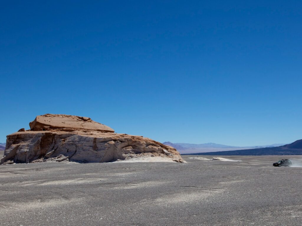 Desert landscape with jeep in distance, North west Argentina