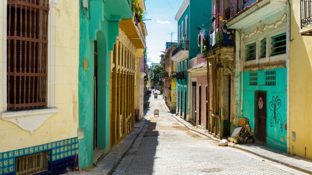street sidelined by colorful old buildings in Havana, Cuba