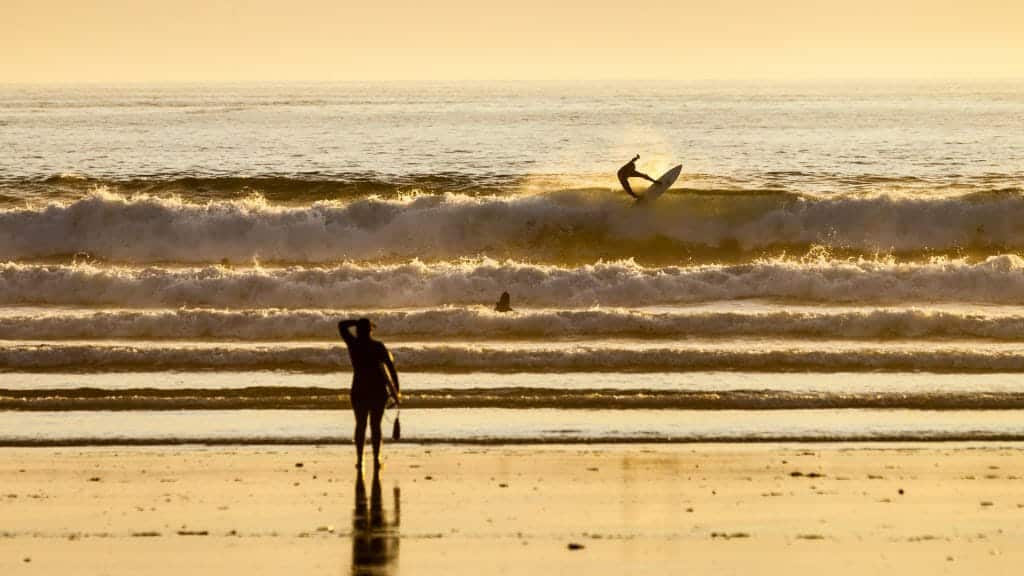 Surfer on the beach in Tofino