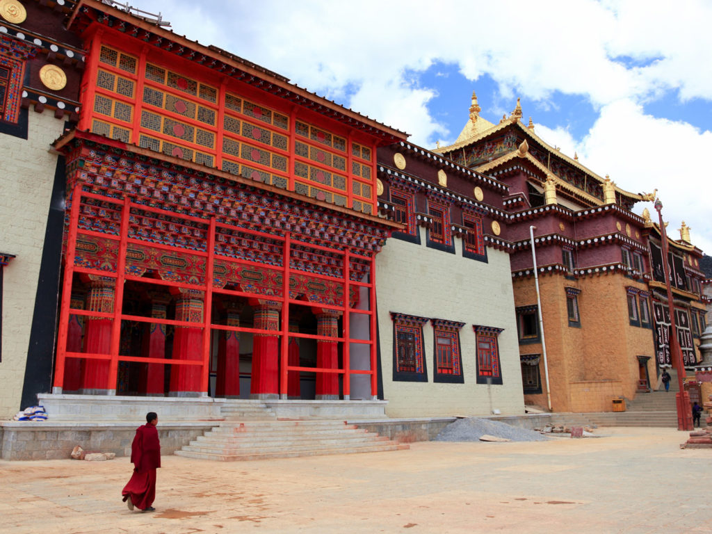 Tibetan Monk walking in Songzanlin Monastery, Shangri La, Yunnan, China