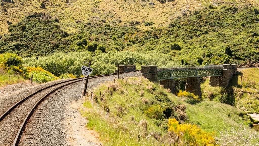 Railway track of Taieri Gorge tourist railway crosses a bridge across a ravine on its journey up the valley