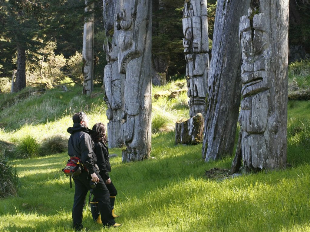 Viewing totems, SGangGwaay, by Kevin J Smith, Haida Gwaii, Canada