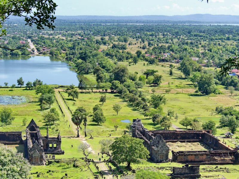 Aerial view of temple complex amid lush landscape.