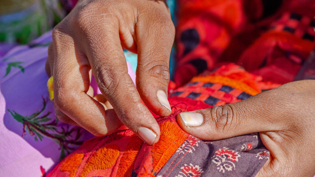 Hands of artist making Embroidery work at Banni area, Bhuj, Gujarat, India