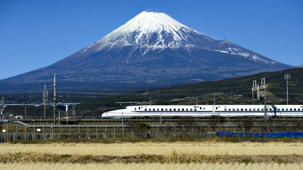 Shinkansen bullet train passing by Mount Fuji, Yoshiwara, Shizuoka prefecture, Japan